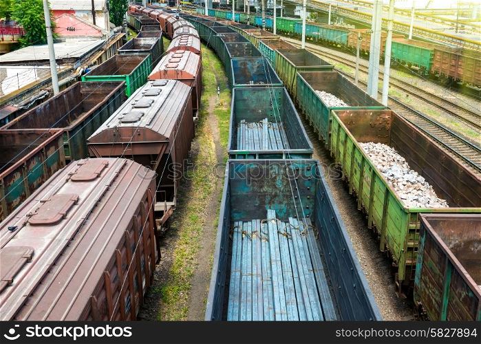 Many trains with cargo wagons on the railroad
