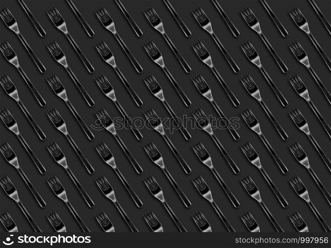 Many transparent plasic forks on gray background, top view. Disposable table wear concept. Creative top view pattern.
