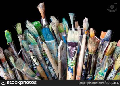 many used brushes for painting and black background