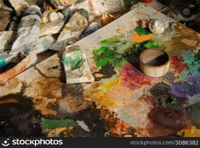 many used tubes of art paint. concept: artistic and creative chaos. art craft, paints