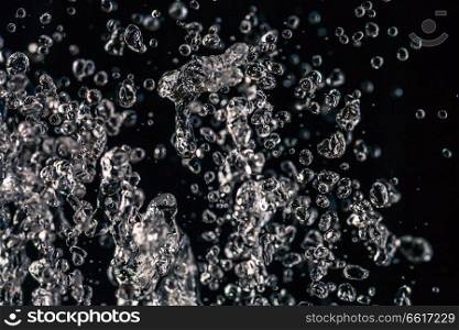 Many water drops frozen in an air on dark background, water concept. Many water drops frozen in an air on dark background