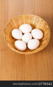 Many white eggs on the wooden table