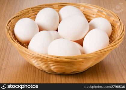 Many white eggs on the wooden table