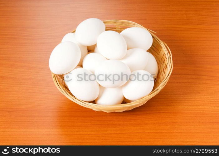 Many white eggs on the wooden table