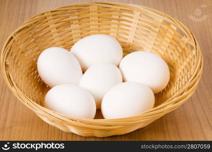 Many white eggs on the wooden table