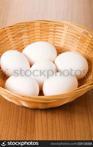 Many white eggs on the wooden table