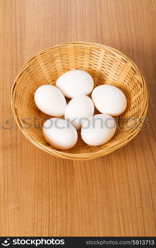 Many white eggs on the wooden table