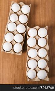 Many white eggs on the wooden table