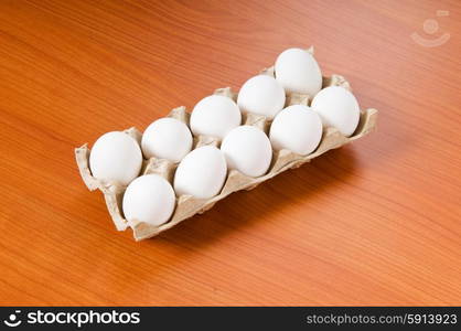 Many white eggs on the wooden table