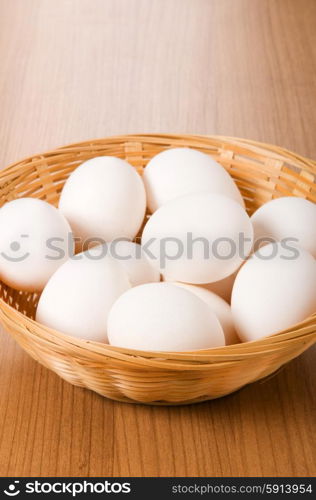 Many white eggs on the wooden table