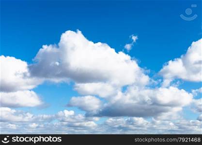 many white puffy clouds in blue spring sky