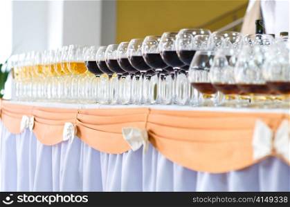 many wine glasses on the banquet table, selective focus, very shallow DOF. array of wineglasses, selective focus