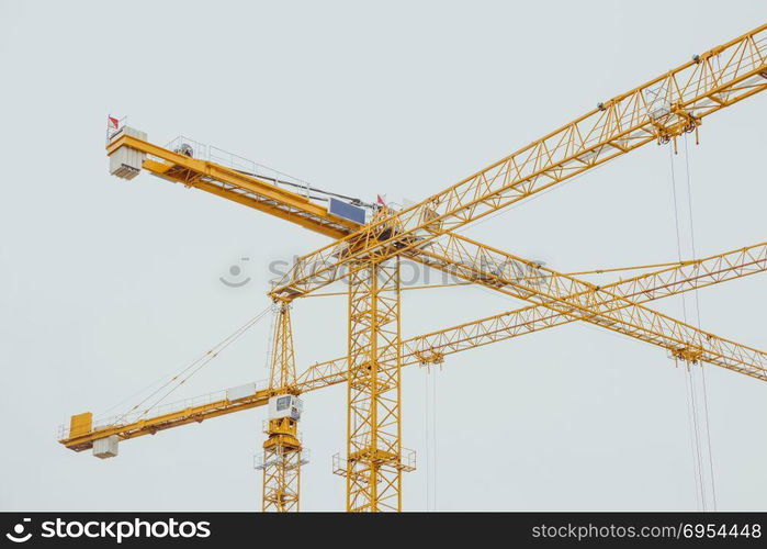 Many yellow construction cranes in winter day at the city of berlin.