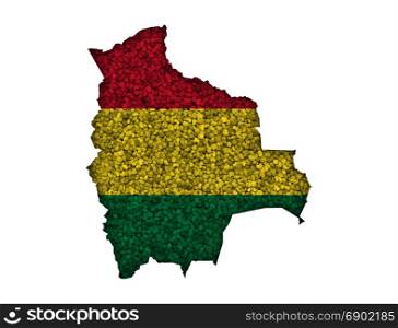 Map and flag of Bolivia on poppy seeds