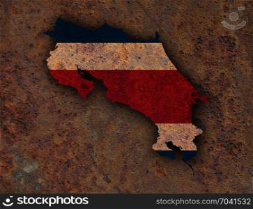 Map and flag of Costa Rica on rusty metal