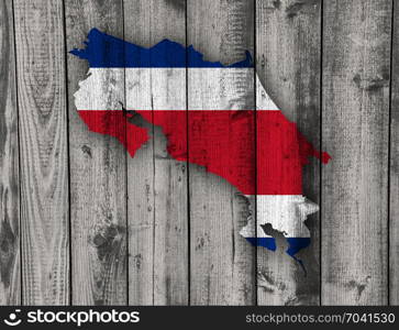 Map and flag of Costa Rica on weathered wood