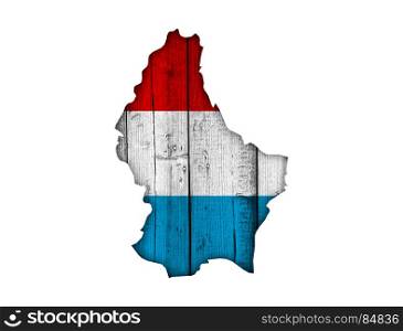 Map and flag of Luxembourg on weathered wood