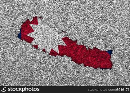 Map and flag of Nepal on poppy seeds