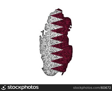 Map and flag of Qatar on poppy seeds