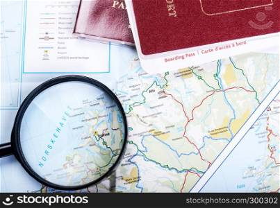 Map, magnifier and tablet. Map of fjords and magnifier and passport