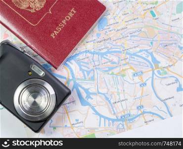 Map of Hamburg with a camera and passport.. Close-up of a Hamburg map with a camera and passport