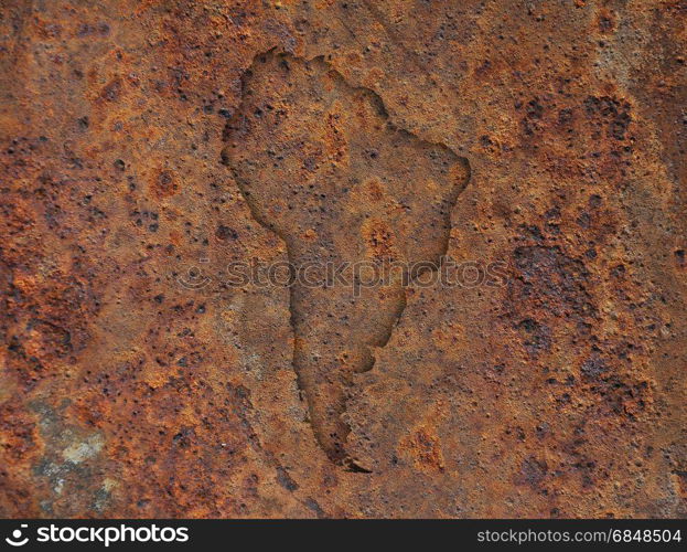 Map of South America on rusty metal