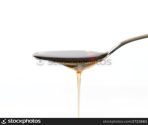 Maple Syrup Overflowing Off A Silver Dessert Spoon
