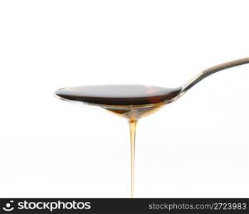 Maple Syrup Overflowing Off A Silver Dessert Spoon