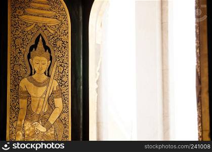 MAR 24, 2018 Bangkok - Thailand :  Golden buddhist mural painting at gate of Wat Trimitr in Chinatown - Yaowarat