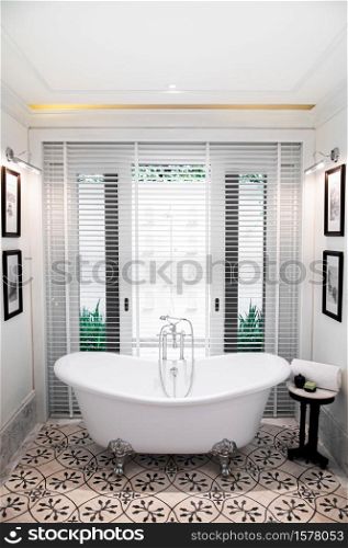 MAR 5, 2012 Chiang Mai, Thailand - White ceramic bathtub inAsian contemporary design bathroom with bright natural light