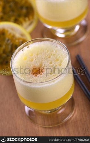 Maracuya Sour, a popular Peruvian cocktail made of maracuya and lime juice, pisco, syrup and egg white (Selective Focus, Focus on the middle of the froth around the angostura drop)