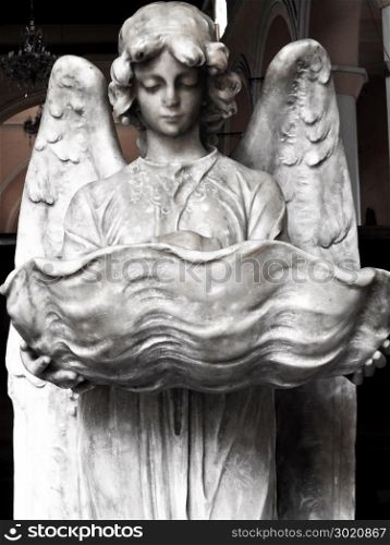 marble angel sculpture holding vase
