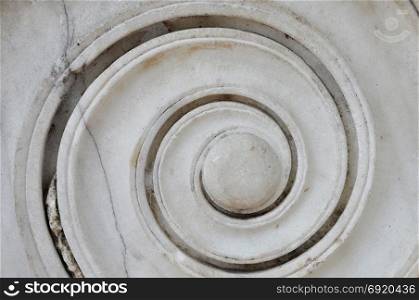 Marble spiral ancient greek ionic column detail. Abstract background.