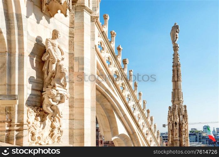 Marble spire, statues and decoration on roof terrace of Duomo di Milano. Milan, Italy