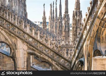 Marble statues - architecture on roof of Duomo gothic cathedral in Milan