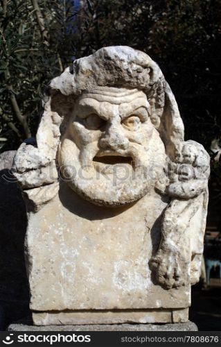 Marble theater mask in castle Bodrum, Turkey