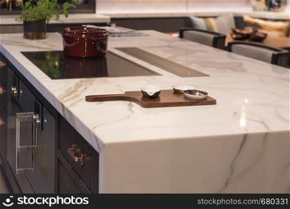 Marble Top Kitchen Island with Ceramic Bowls on wooden board