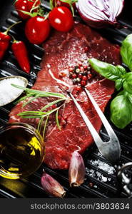 Marbled beef steak with meat fork and vegetables in a grill pan