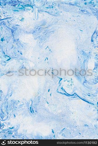 Marbleized effect. Ancient oriental drawing technique. Marble texture. Beautiful pattern. Marbling background. Blue and white mixed oil paints.