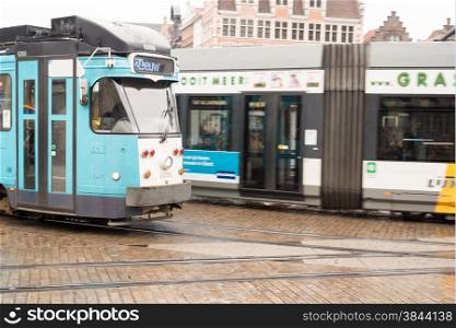 March 2015- Ghent, Belgium - Moving Tram on Cobbled Street .