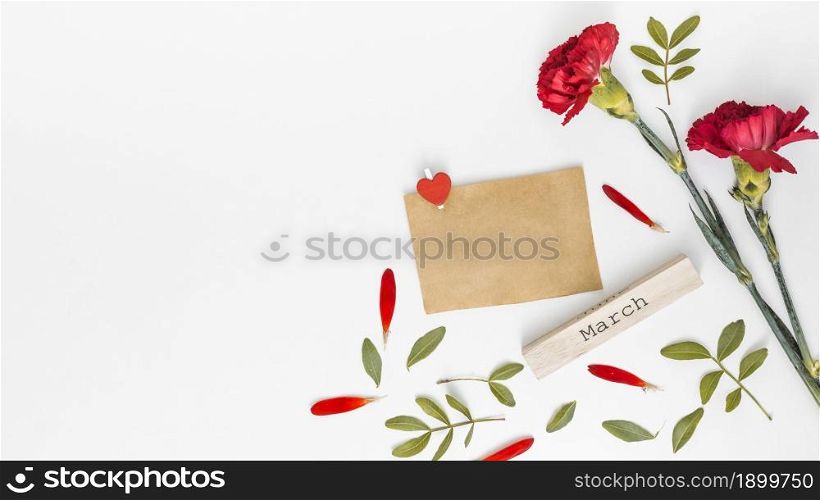 march inscription with red carnation flowers paper. Resolution and high quality beautiful photo. march inscription with red carnation flowers paper. High quality beautiful photo concept