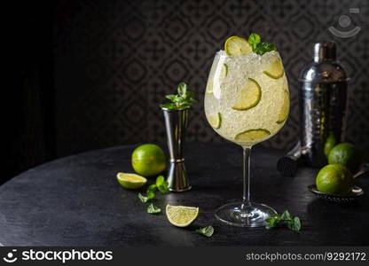 Margarita cocktail with lime and ice on dark wooden table with copy space. Classic Margarita and Daiquiri Cocktail.. Margarita cocktail with lime