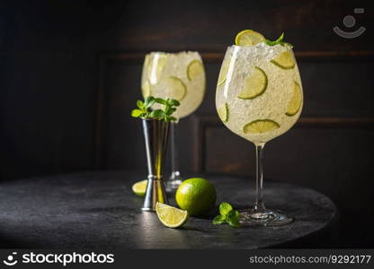 Margarita cocktail with lime and ice on dark wooden table with copy space. Classic Margarita and Daiquiri Cocktail.. Margarita cocktail with lime