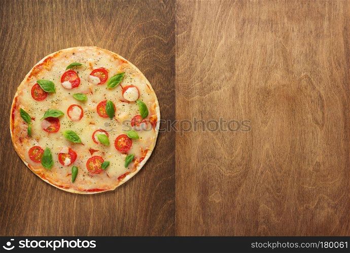margarita pizza at wooden table, top view