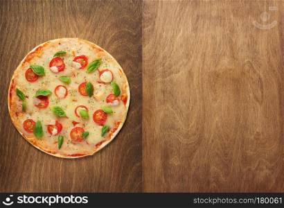 margarita pizza at wooden table, top view