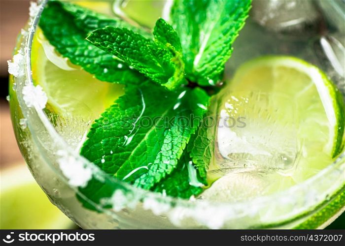 Margarita with mint, lime and ice. Macro background. High quality photo. Margarita with mint, lime and ice.