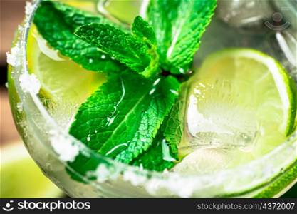 Margarita with mint, lime and ice. Macro background. High quality photo. Margarita with mint, lime and ice.
