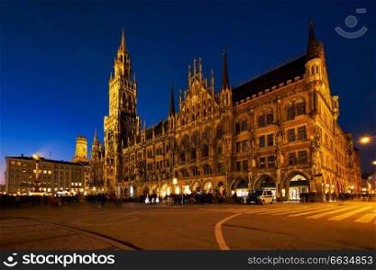 Marienplatz central square illuminated at night with New Town Hall (Neues Rathaus) - a famous tourist attraction. Munich, Germany. Marienplatz square at night with New Town Hall Neues Rathaus