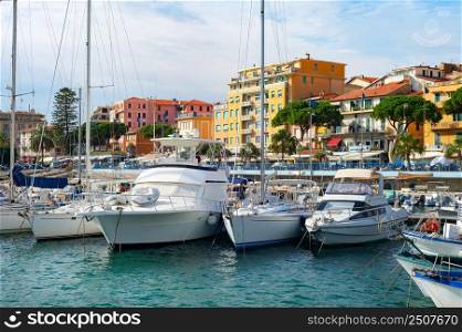 Marina with yaschts in bright sunhine,cityscape in background, Sanremo, Itlay
