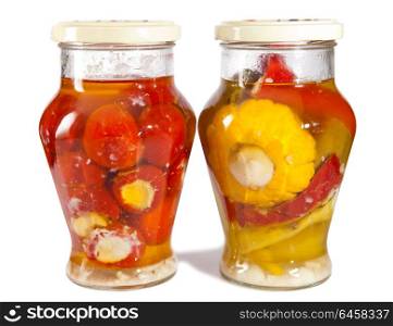 Marinaded tomatoes, stuffed and bush pumpkins and vegetable marrows in a glass jar